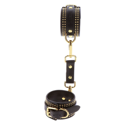 Taboom Vogue studded black leather ankle cuffs with gold hardware.