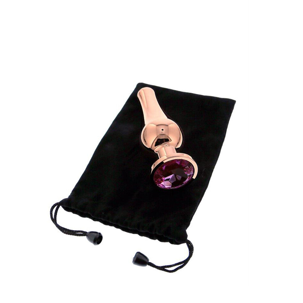 Rose gold gem butt plug on velvet bag.
