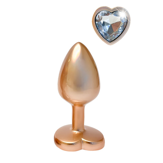 Gold tone butt plug with a heart shaped jewel.
