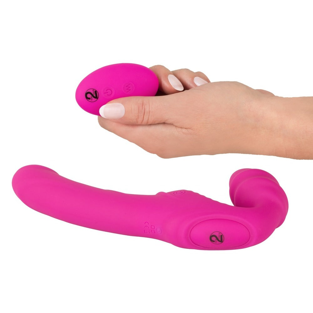 Pink strap-on and remote control for adventurous fun.
