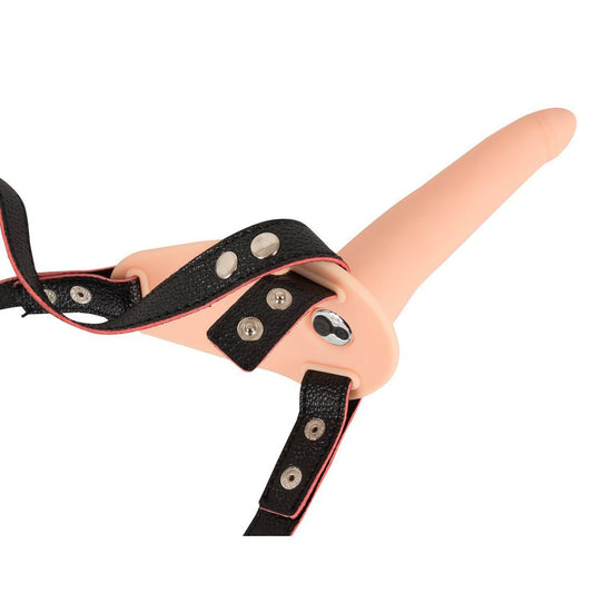 Strap-on vibrator with a realistic dildo and black adjustable harness, promising thrilling sensations and inclusive fun.