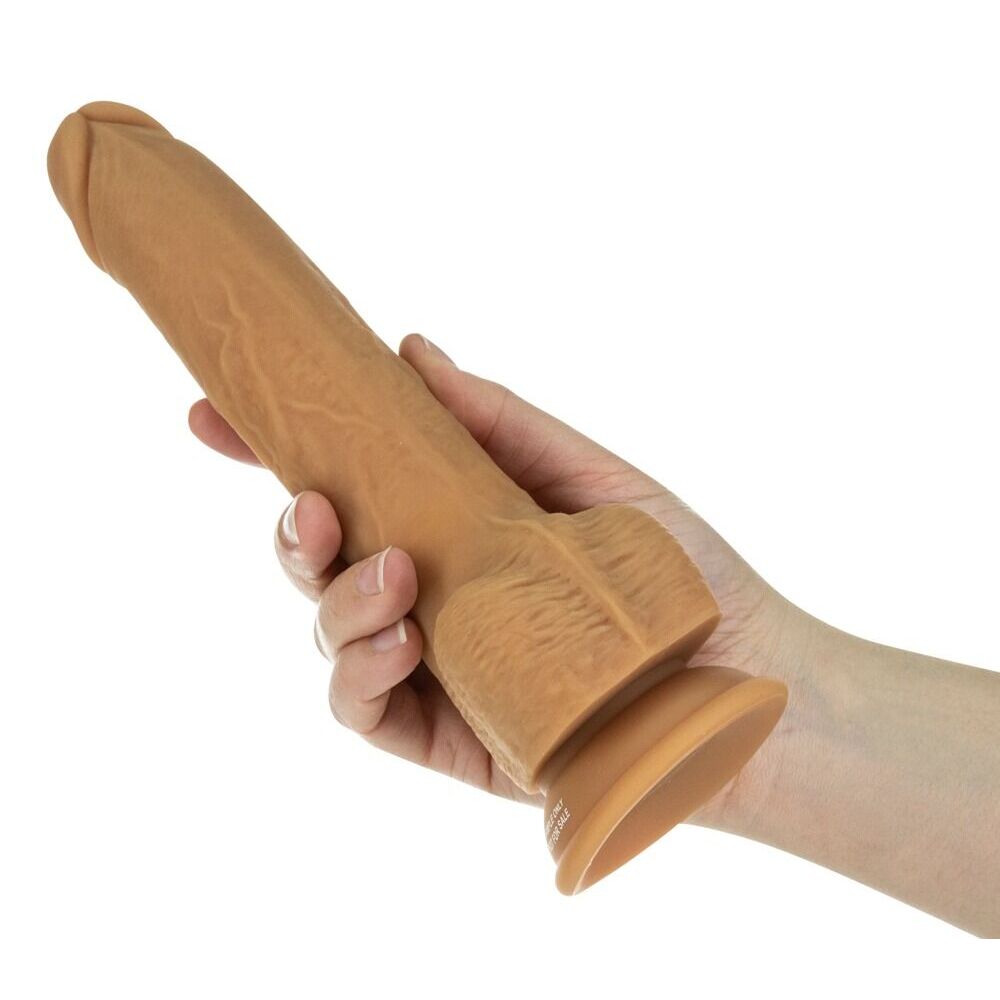 Caramel coloured thrusting dildo in hand.