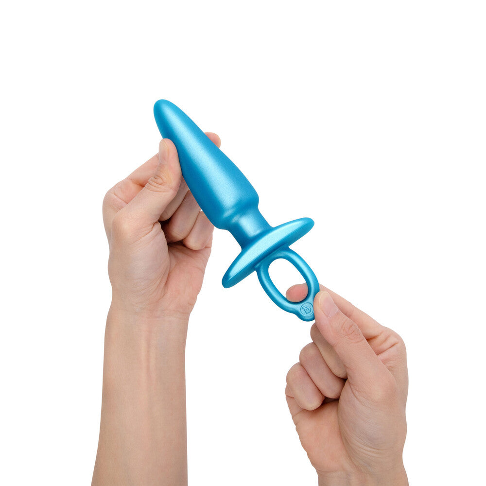 Sleek blue prostate plug, B-Vibe held in two hands, ready for pleasure.