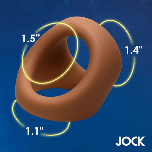 Tan silicone cock and ball ring with yellow measurements on blue.