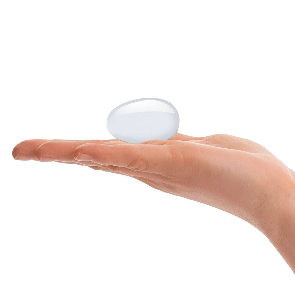 Hand holding clear glass yoni egg