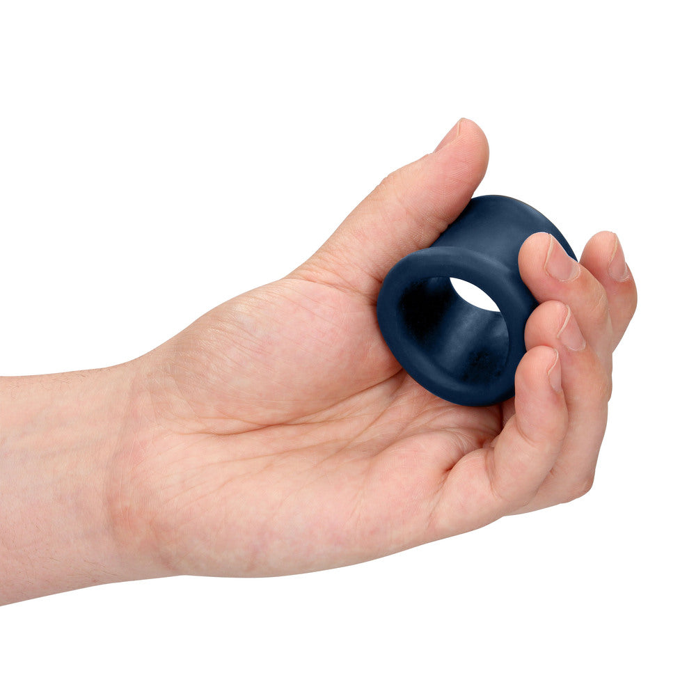 Blue cock ring held in palm