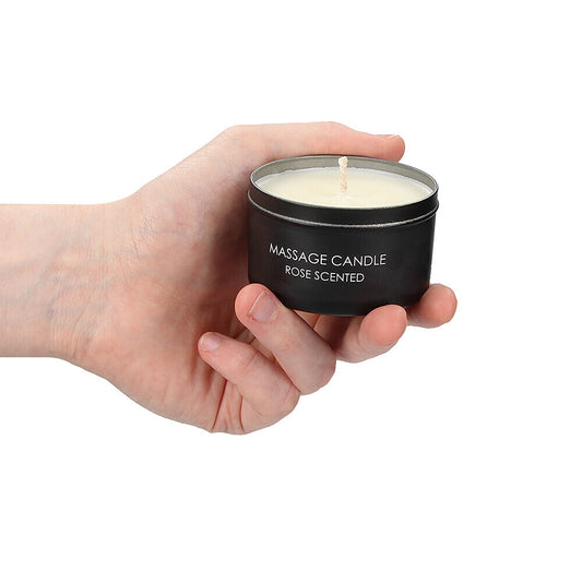 Hand holding rose scented massage candle