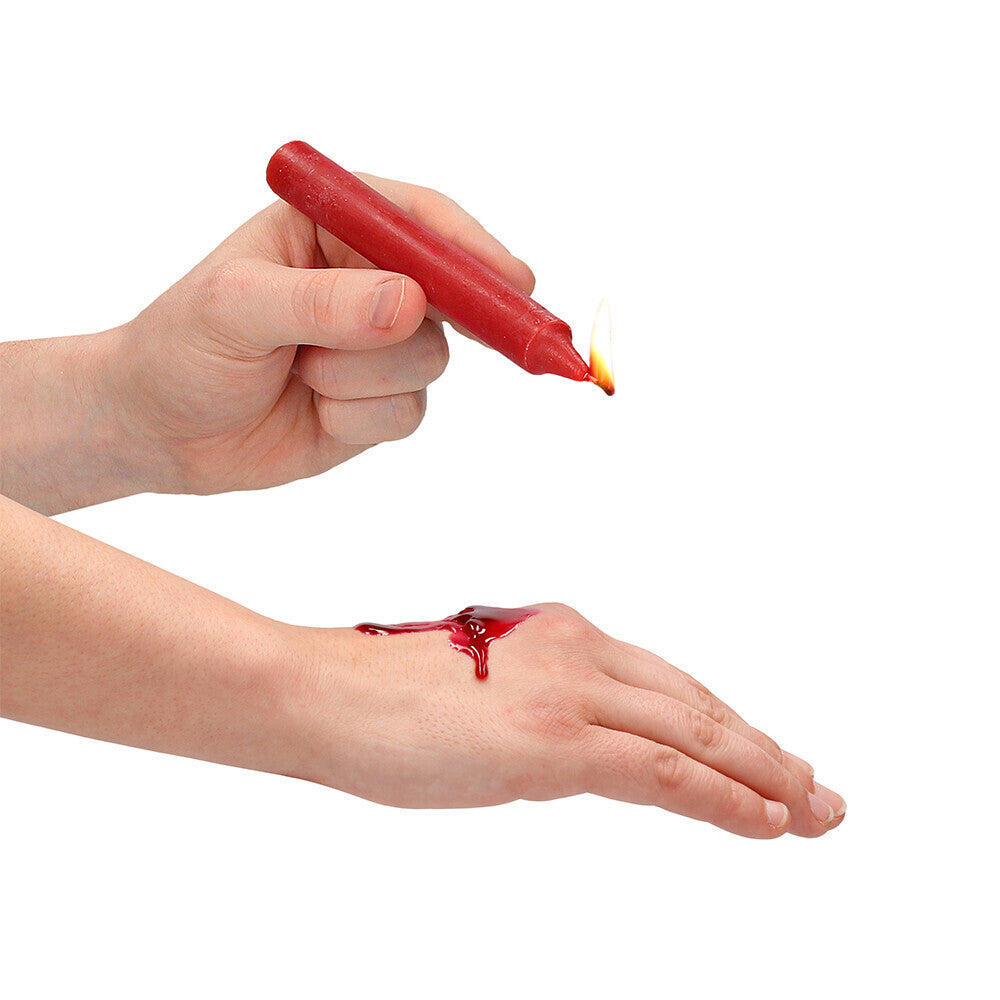 Teasing wax candle dripping onto a hand