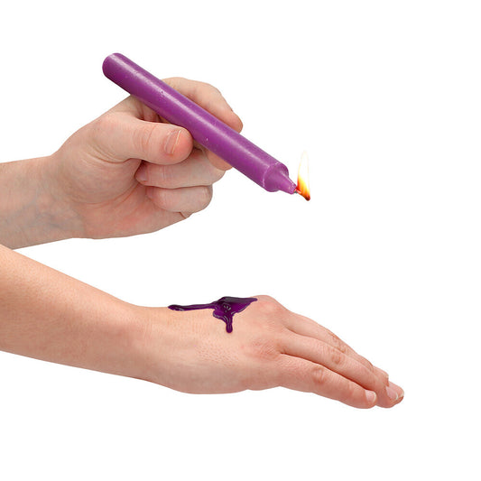 Teasing wax candle being dripped onto a hand.