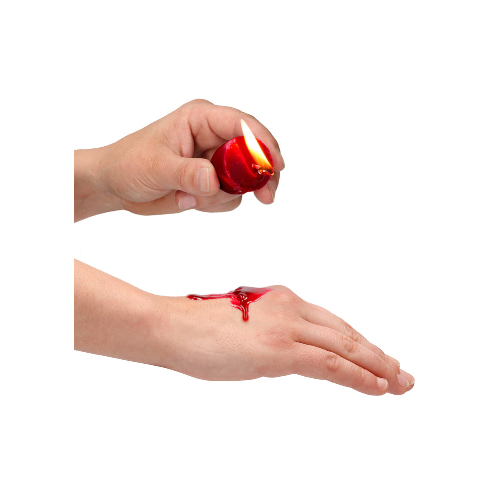 Scented teasing wax candle on skin