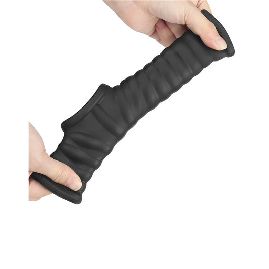 Black textured Lovetoy penis sleeve held by hands.