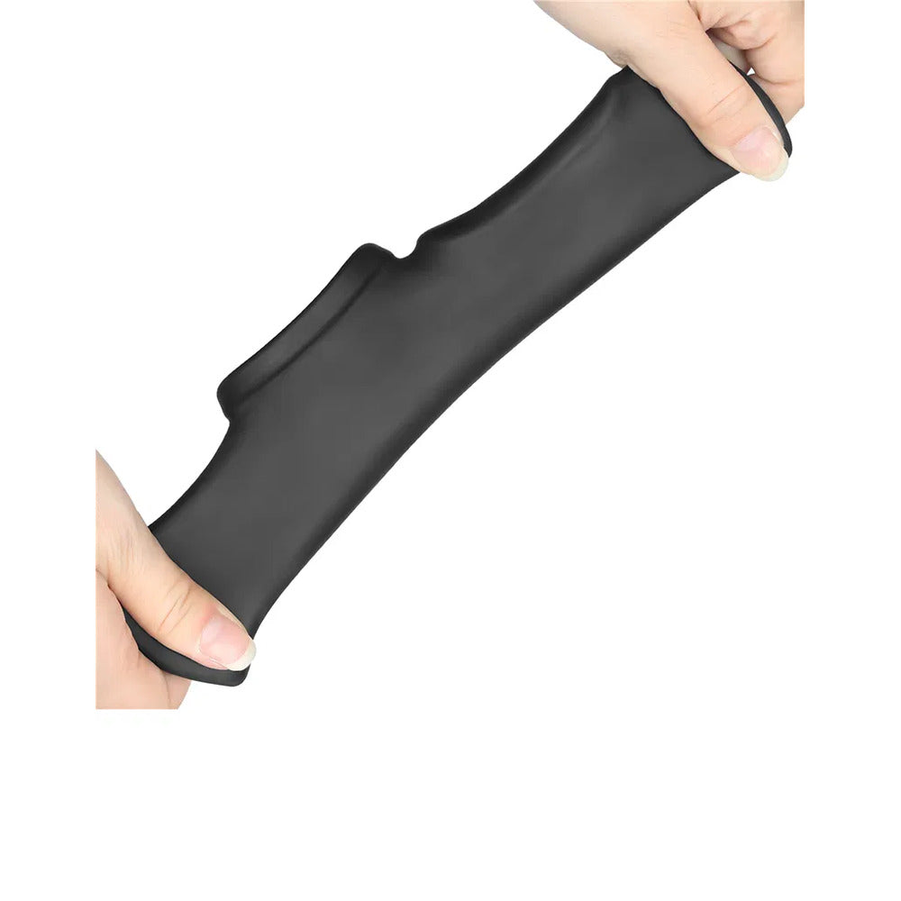Hands holding a black penis sleeve toy