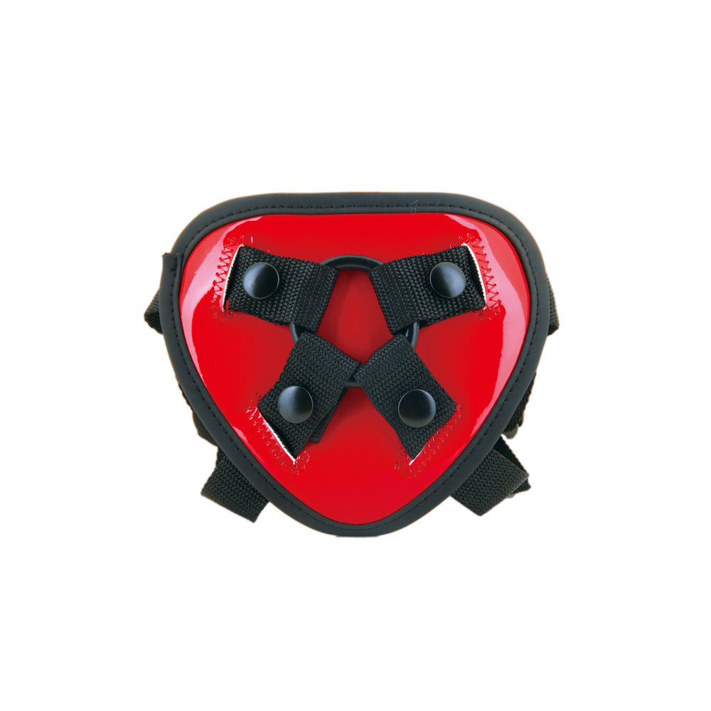 Red, heart-shaped bondage accessory with black straps.