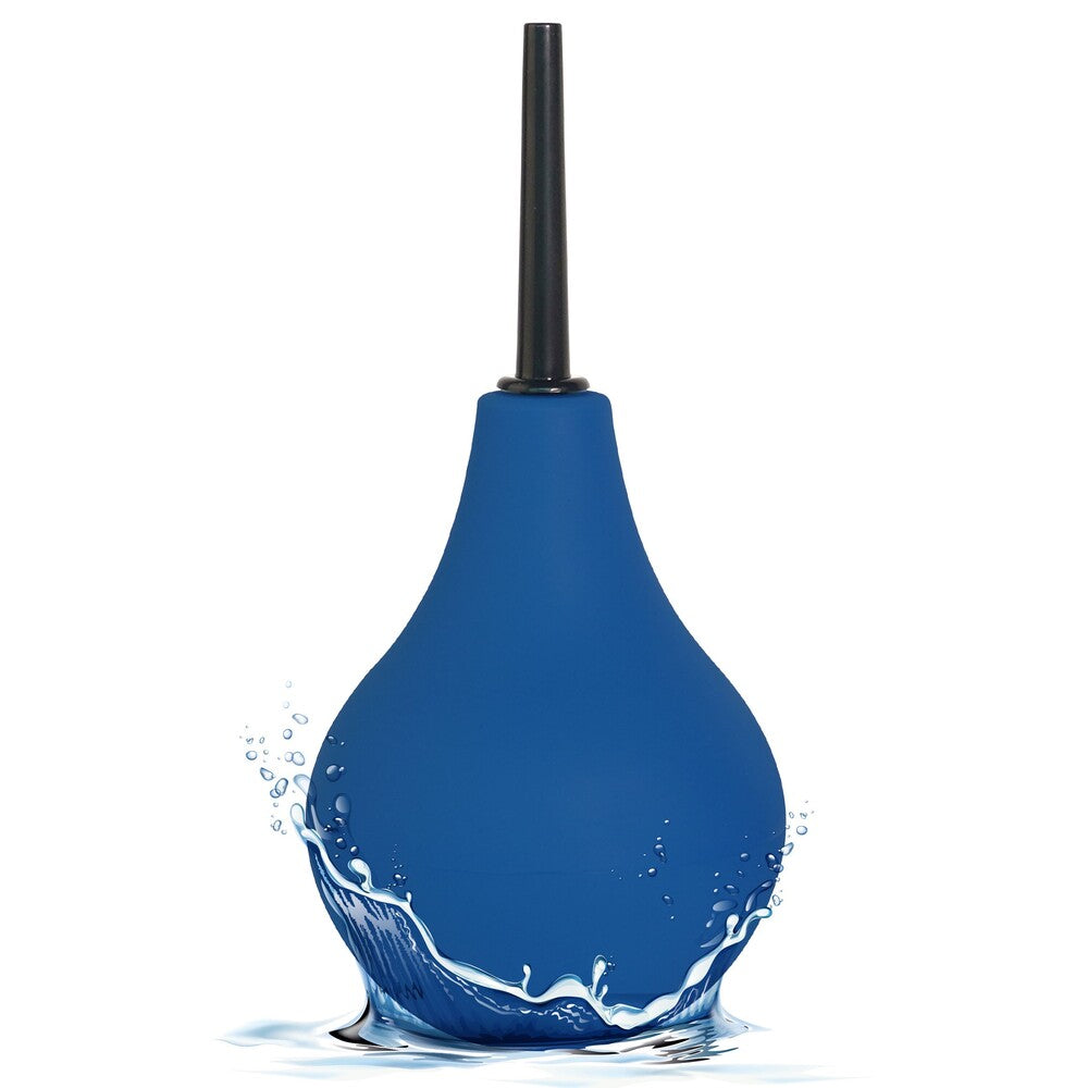 Blue enema bulb with a black nozzle, standing in a splash of water.