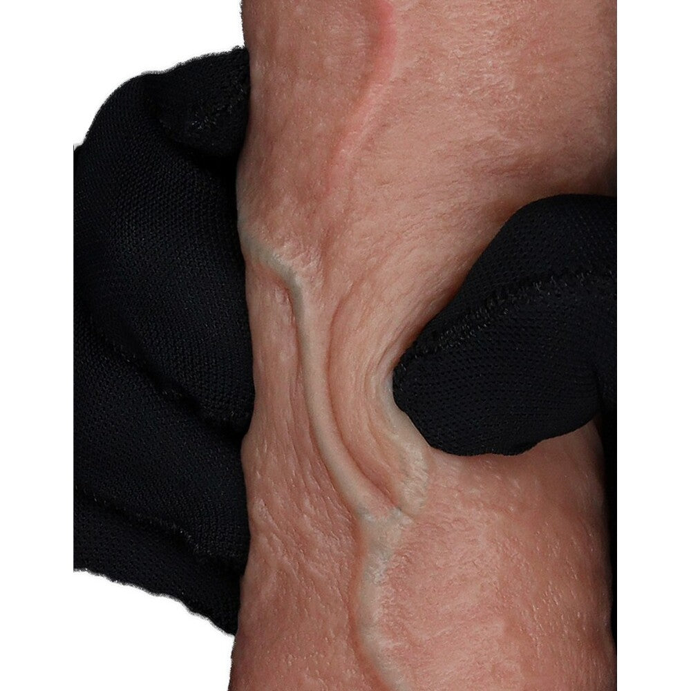 Skin texture being held by a black gloved hand