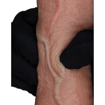Skin texture being held by a black gloved hand