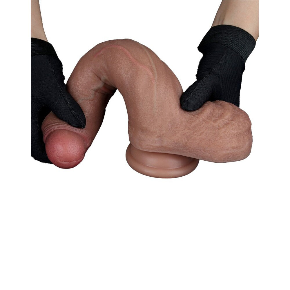 Lovetoy realistic dual layered dildo held by black gloved hands.
