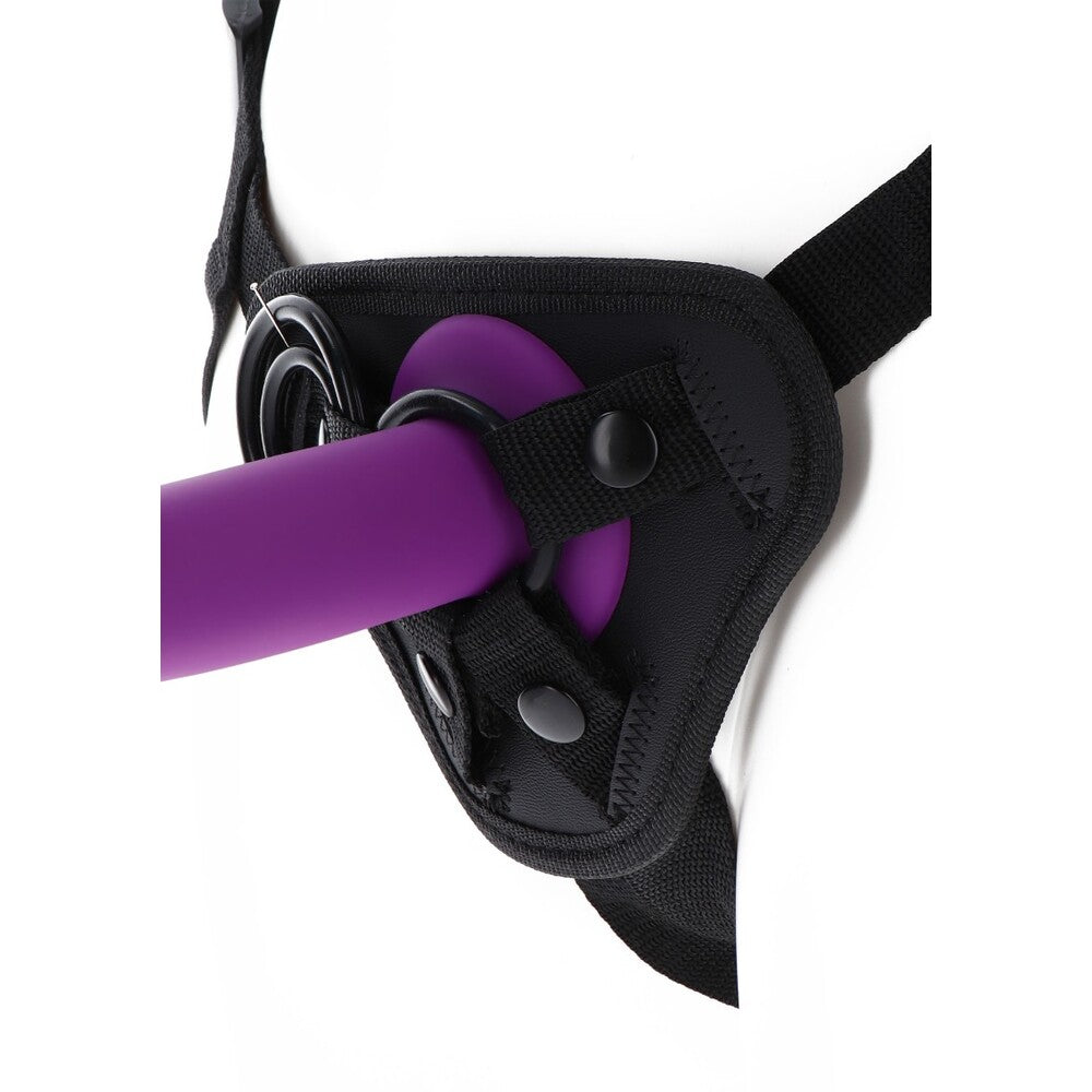 Purple dildo in a black strap-on harness, ready for pleasure. Get Real at Toy Joy!