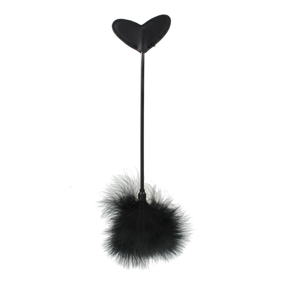 Heart-shaped paddle with black feather tickler.
