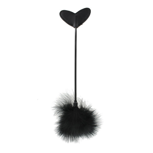 Heart-shaped paddle with black feather tickler.