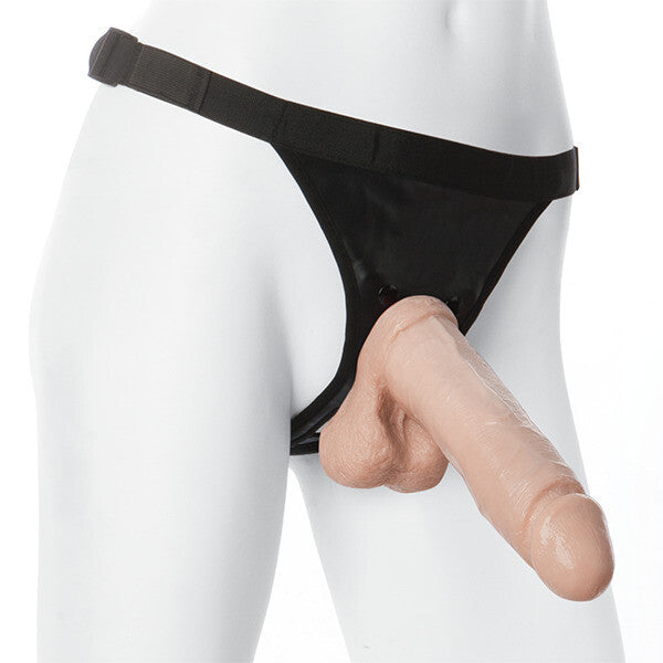 Black harness with realistic-looking, eight-inch prosthetic cock attachment.