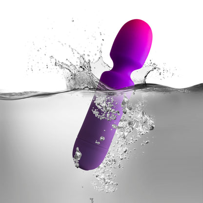 Purple GloGirl wand massager plunges playfully into water, creating splashes.
