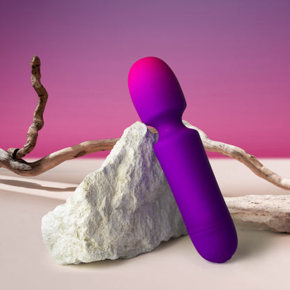 Rocks Off GloGirl Wand Massager in vibrant pink & purple, styled with natural textures. Pleasure awaits!
