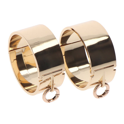 Gold-toned metal wrist cuffs from Taboom.