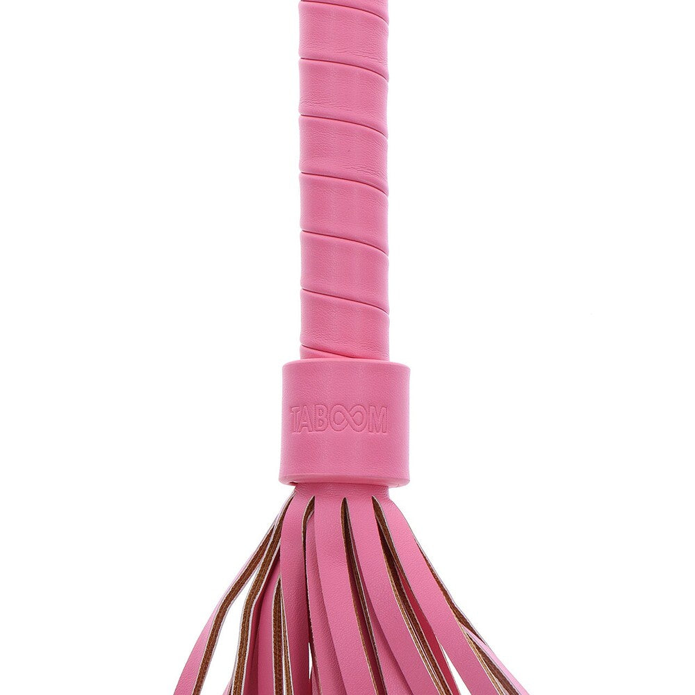 Close-up of a pink Taboom Malibu Whip toy with a fringed end.