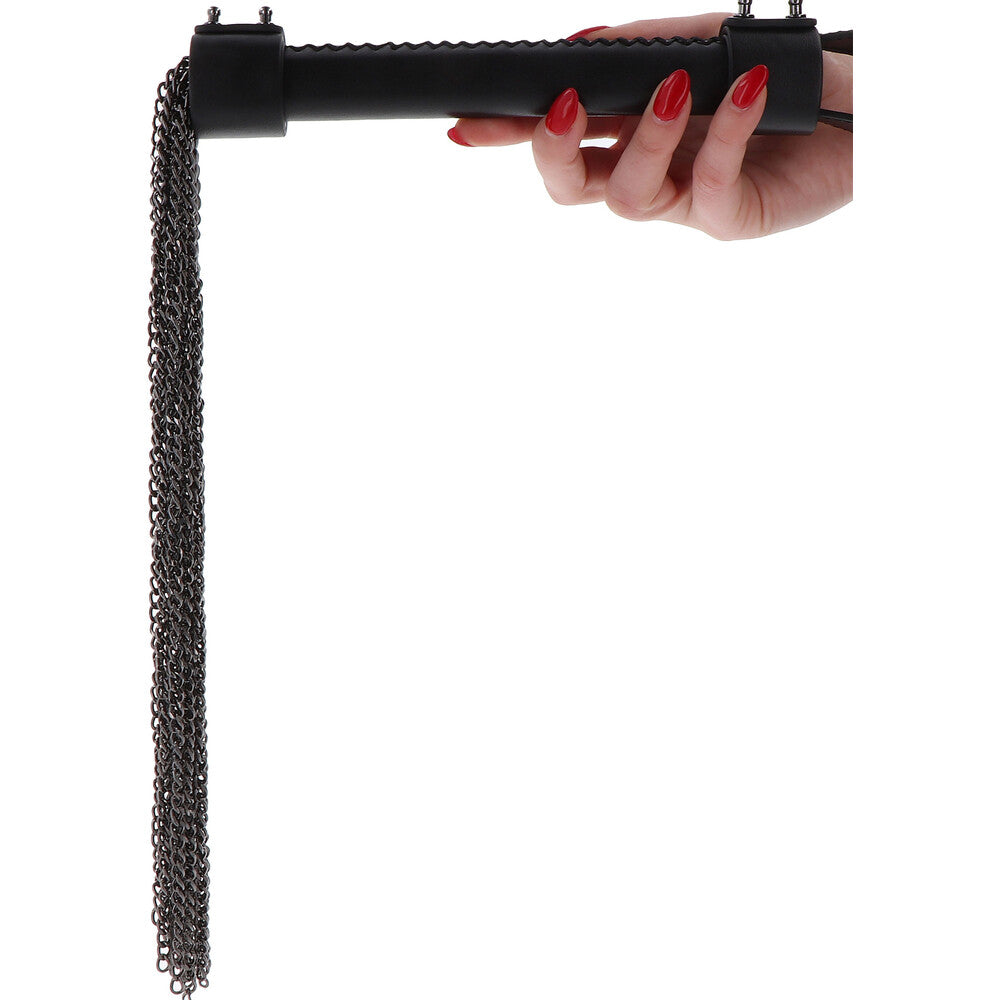 Woman's hand holds black chain whip from Hidden Desire.