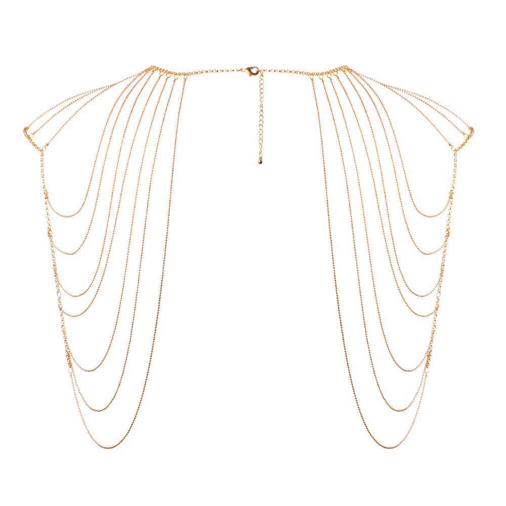 Glimmering gold shoulder jewellery. Drape yourself in delicate chains, a playful adornment.