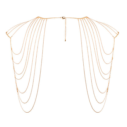 Glimmering gold shoulder jewellery. Drape yourself in delicate chains, a playful adornment.