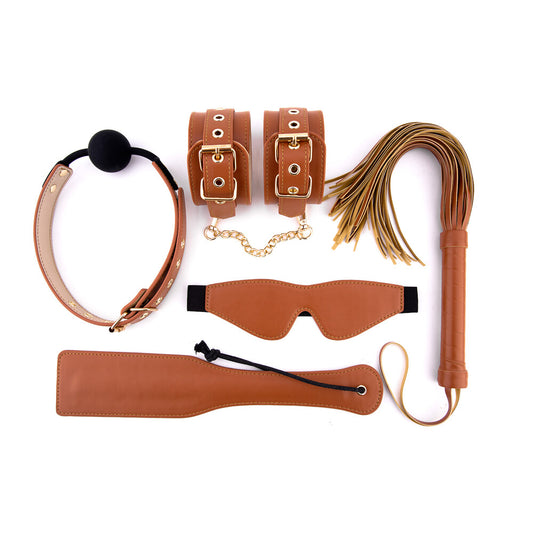 Cognac vegan leather BDSM set: cuffs, gag, flogger, blindfold, and paddle.