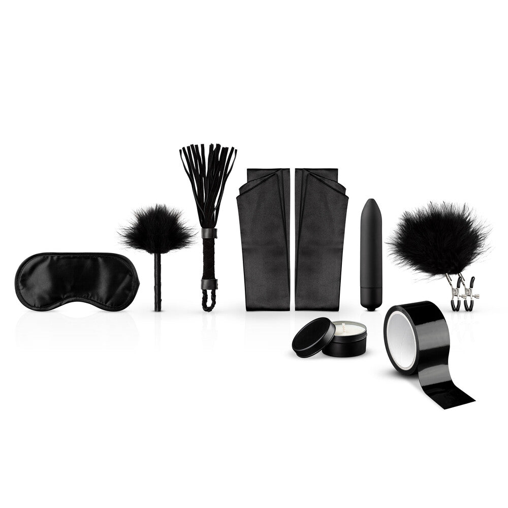 Black kinky starter kit including blindfold, flogger, tickler, restraints, bullet vibrator, nipple clamps, candle and tape.