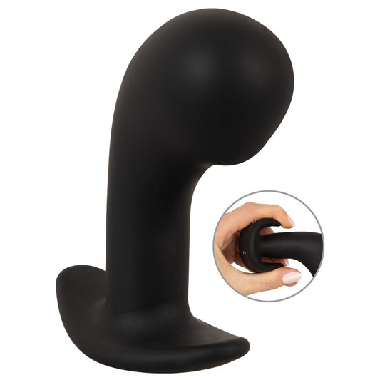 Black silicone prostate plug with a bulbous head, comfortable base and hand squeezing it.