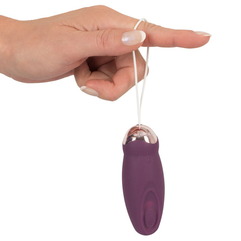 Hand holds purple Javida rechargeable love ball.