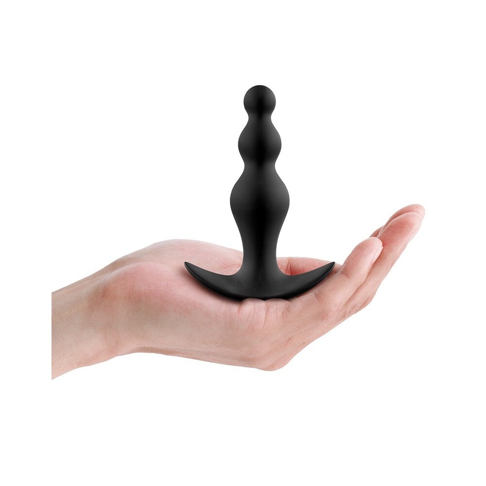 Black anal beads on palm.