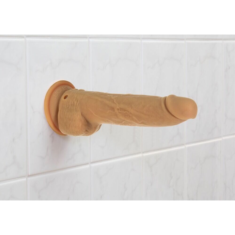 Caramel dildo with suction cup base, ready for cheeky fun on the tiles.
