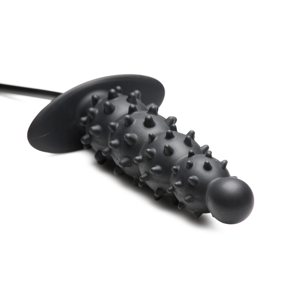 Intriguing black rubber nubbed anal plug for adventurous play. A thrilling invitation to explore new depths of sensation.