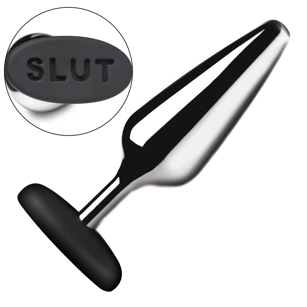 Shiny metal butt plug with "SLUT" on the base.