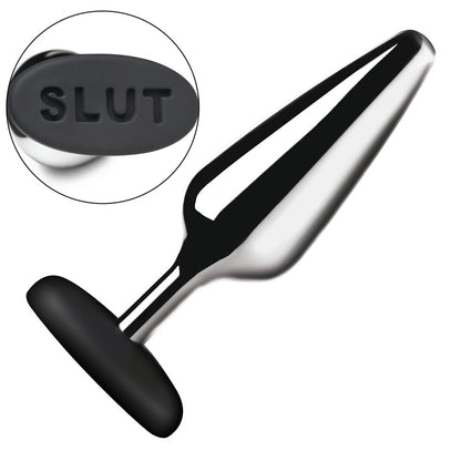 Shiny metal butt plug with "SLUT" on the base.
