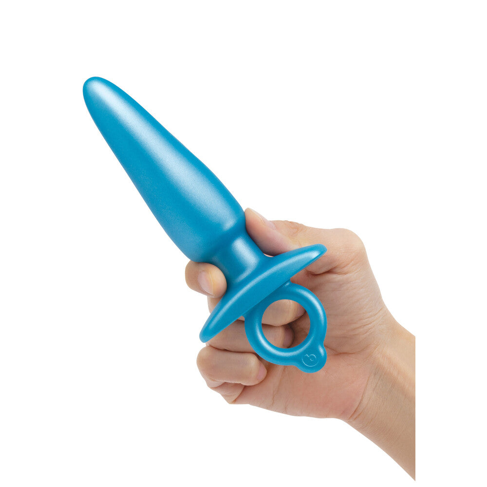 Turquoise prostate plug held in hand