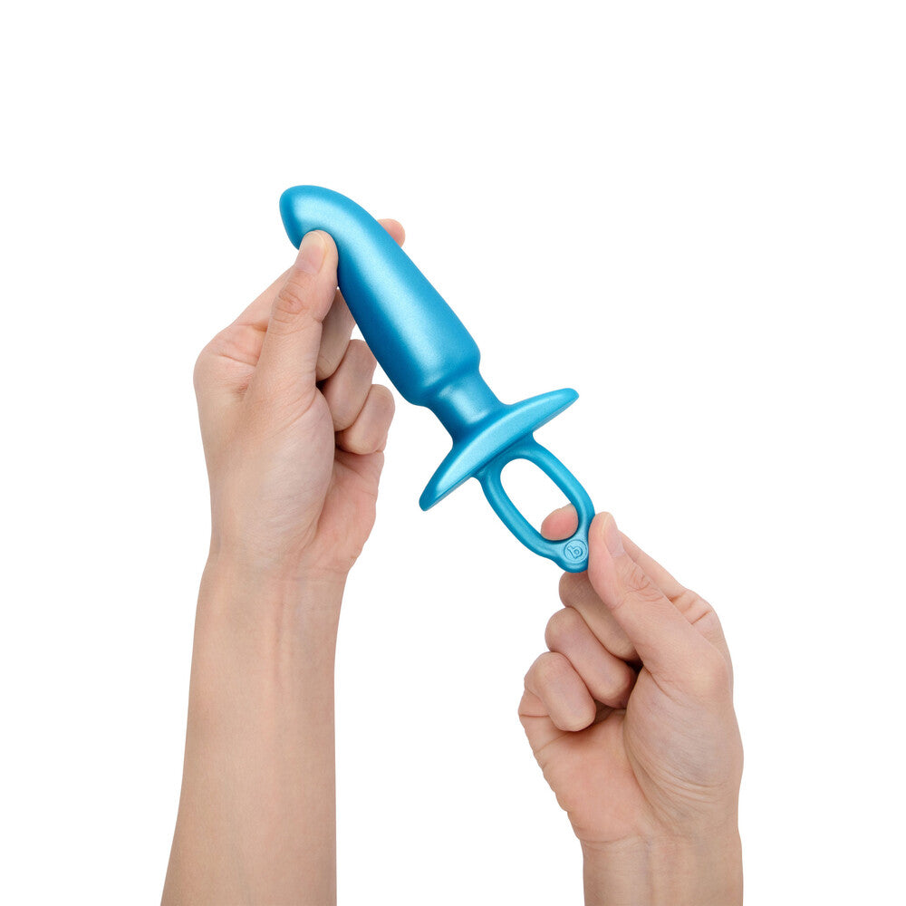 Hands holding a blue Hither prostate plug by B-Vibe.