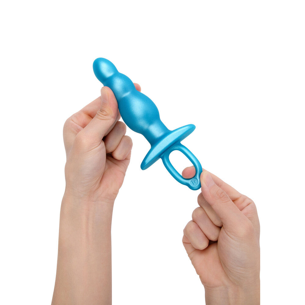 Blue B-Vibe Bounce Plug held by hands.