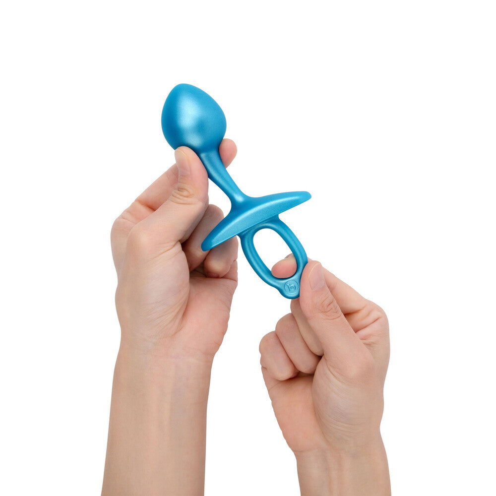 Teal B-Vibe bulb plug toy held in hands. Time to explore your sensual side!