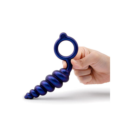 A hand holds a blue, beaded B-Vibe Buttie Plug, ready for a cheeky adventure.