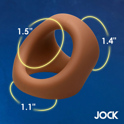 Tan silicone cock and ball ring with yellow measurements on blue.
