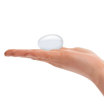 Hand holding clear glass yoni egg