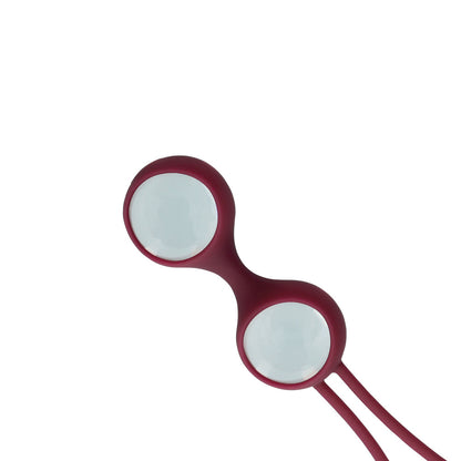Burgundy vaginal weights for pelvic floor exercises.