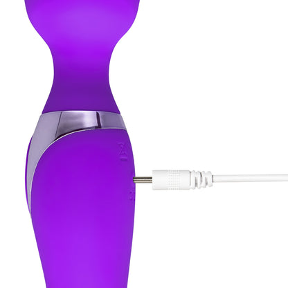 A tantalising peek at a vibrant, purple wand massager as it's charged, promising pleasure and self-love.
